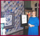 Picture of Dottie with art quilt "Twilight Garden Rain"